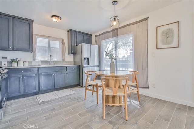 1327 Exposition Blvd, Los Angeles, CA 90018 - kitchen with fridge with ice dispenser, light countertops, wood finish floors, and pendant lighting