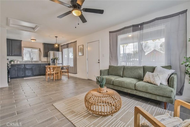 1327 Exposition Blvd, Los Angeles, CA 90018 - living room with attic access, a ceiling fan, and light wood-style floors