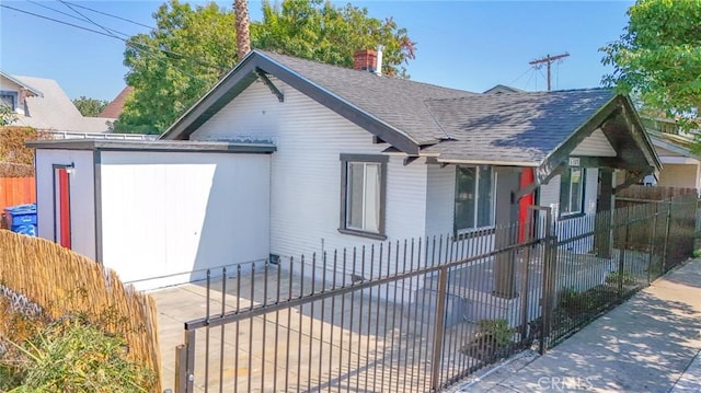 1327 Exposition Blvd, Los Angeles, CA 90018 - view of front of house with roof with shingles, a fenced front yard, and a chimney