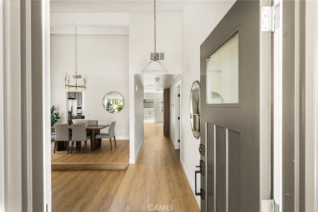 16917 Eric Ave, Cerritos, CA 90703 - foyer with light wood-type flooring, a chandelier, and a towering ceiling