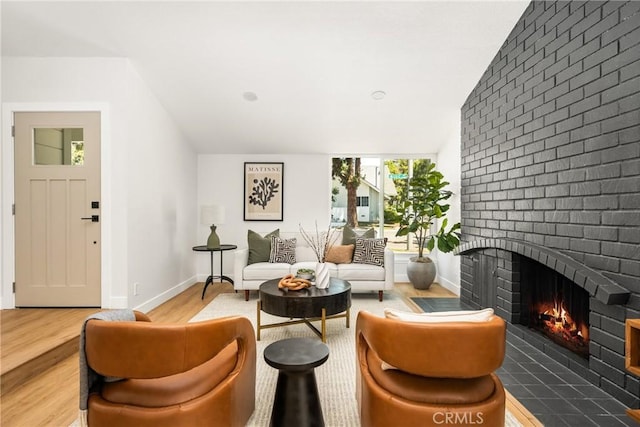 16917 Eric Ave, Cerritos, CA 90703 - sitting room with a brick fireplace and wood finished floors