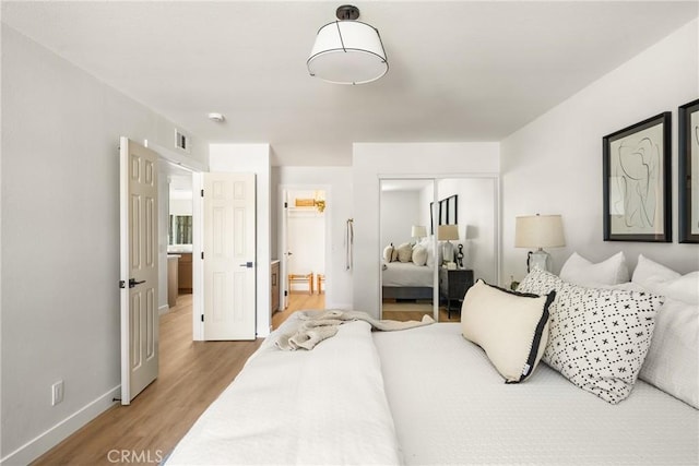 16917 Eric Ave, Cerritos, CA 90703 - bedroom with light wood-style flooring, a closet, and ensuite bath