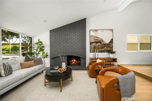 16917 Eric Ave, Cerritos, CA 90703 - living room featuring vaulted ceiling, a fireplace, and wood finished floors