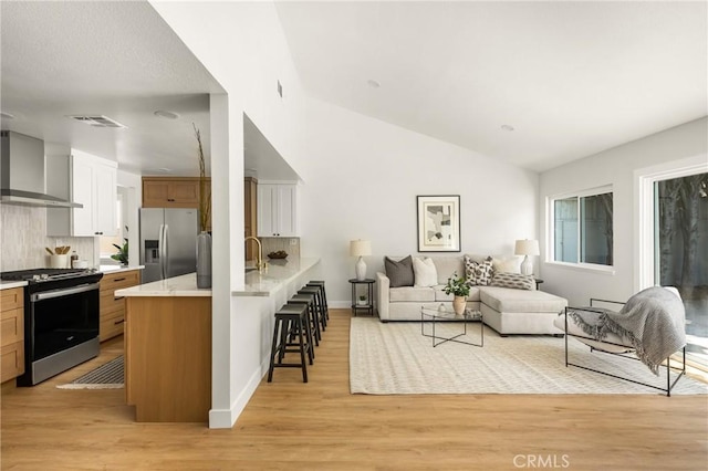 16917 Eric Ave, Cerritos, CA 90703 - living room featuring light wood finished floors and lofted ceiling