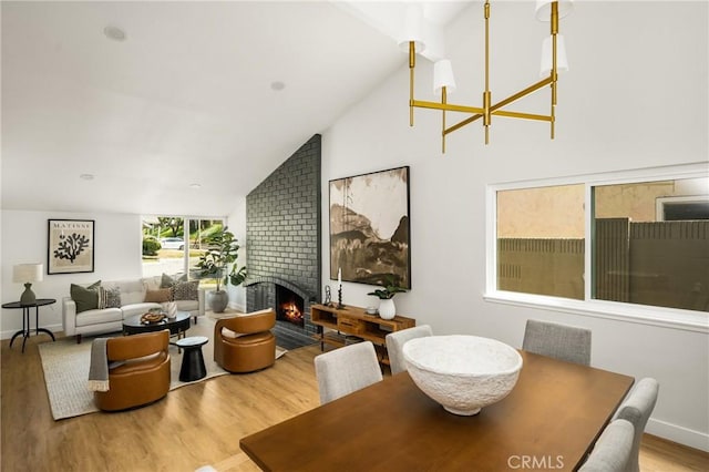 16917 Eric Ave, Cerritos, CA 90703 - dining space with wood finished floors, a fireplace, and high vaulted ceiling