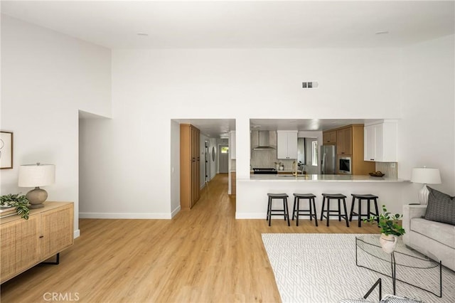 16917 Eric Ave, Cerritos, CA 90703 - living room featuring a high ceiling and light wood-style flooring