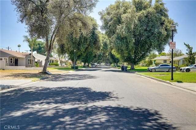 8084 Magnolia Ave, Riverside, CA 92504 - view of asphalt road featuring street lights, curbs, and a residential view
