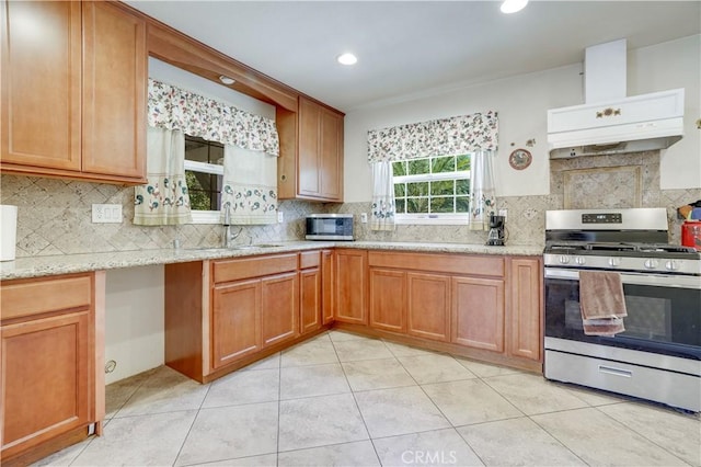 8084 Magnolia Ave, Riverside, CA 92504 - kitchen with appliances with stainless steel finishes, premium range hood, decorative backsplash, light stone counters, and light tile patterned floors