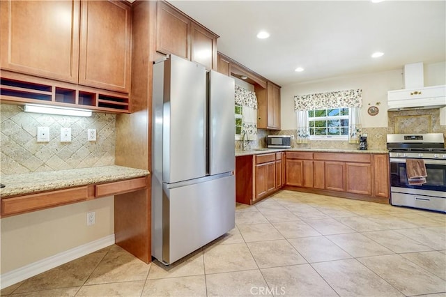 8084 Magnolia Ave, Riverside, CA 92504 - kitchen with appliances with stainless steel finishes, decorative backsplash, light tile patterned flooring, custom exhaust hood, and light stone countertops
