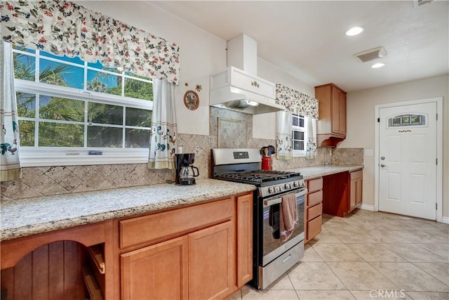 8084 Magnolia Ave, Riverside, CA 92504 - kitchen with stainless steel gas range oven, decorative backsplash, light tile patterned flooring, light stone countertops, and recessed lighting