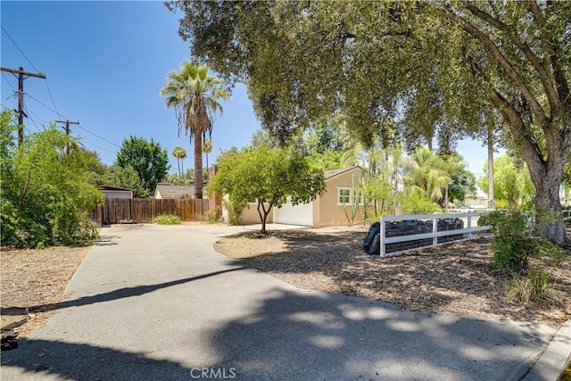 8084 Magnolia Ave, Riverside, CA 92504 - view of yard with concrete driveway and a garage