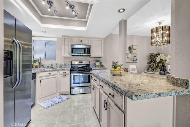 28191 Sorrento Unit 111, Laguna Niguel, CA 92677 - kitchen featuring stainless steel appliances, a raised ceiling, light stone counters, light marble finish floors, and a chandelier