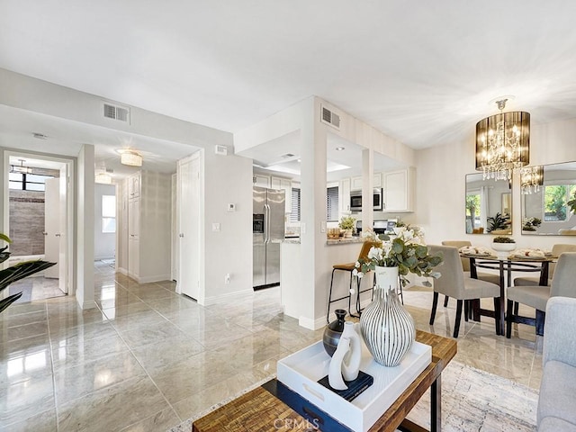 28191 Sorrento Unit 111, Laguna Niguel, CA 92677 - living area with plenty of natural light, light marble finish floors, and a chandelier
