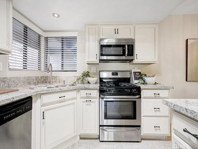 28191 Sorrento Unit 111, Laguna Niguel, CA 92677 - kitchen featuring appliances with stainless steel finishes, light stone countertops, white cabinetry, and recessed lighting