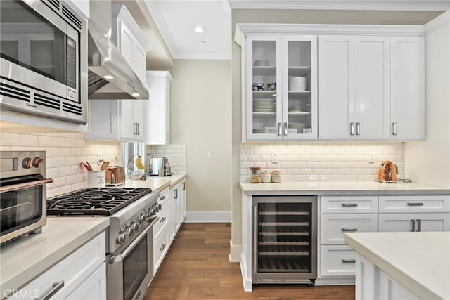 716 Elvira Ave Unit A, Redondo Beach, CA 90277 - kitchen featuring beverage cooler, stainless steel appliances, wall chimney range hood, white cabinetry, and ornamental molding