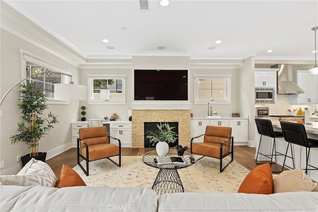 716 Elvira Ave Unit A, Redondo Beach, CA 90277 - living area with crown molding, plenty of natural light, wood finished floors, a fireplace, and recessed lighting