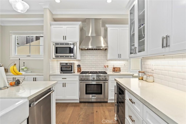 716 Elvira Ave Unit A, Redondo Beach, CA 90277 - kitchen featuring wall chimney exhaust hood, stainless steel appliances, beverage cooler, white cabinetry, and recessed lighting