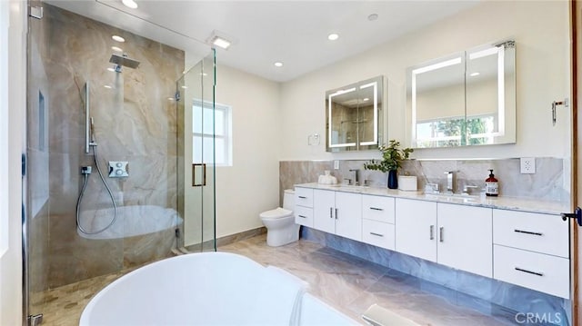 421 N Catalina St, Burbank, CA 91505 - full bath with double vanity, a soaking tub, a marble finish shower, recessed lighting, and decorative backsplash