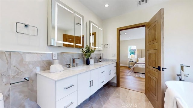 421 N Catalina St, Burbank, CA 91505 - ensuite bathroom featuring double vanity, a freestanding bath, and recessed lighting