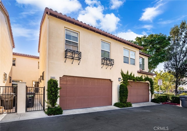 8495 E Preserve Loop, Chino, CA 91708 - mediterranean / spanish-style home with stucco siding, a garage, and a gate