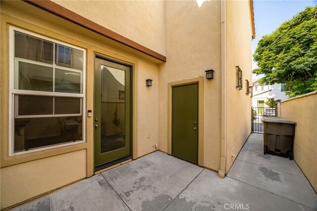 8495 E Preserve Loop, Chino, CA 91708 - view of exterior entry featuring stucco siding, a patio, and a gate