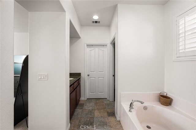 8495 E Preserve Loop, Chino, CA 91708 - full bath featuring vanity, a garden tub, and stone finish flooring