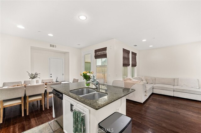8495 E Preserve Loop, Chino, CA 91708 - kitchen with dishwasher, dark stone countertops, an island with sink, dark wood-style floors, and recessed lighting