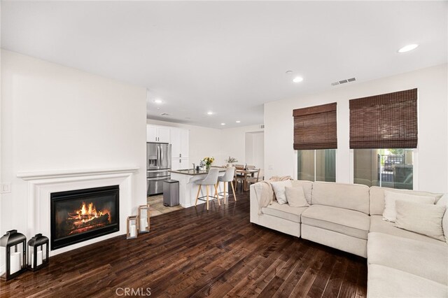 8495 E Preserve Loop, Chino, CA 91708 - living area with dark wood-type flooring, recessed lighting, and a glass covered fireplace