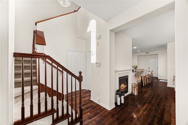 8495 E Preserve Loop, Chino, CA 91708 - foyer featuring wood-type flooring, stairs, and a glass covered fireplace