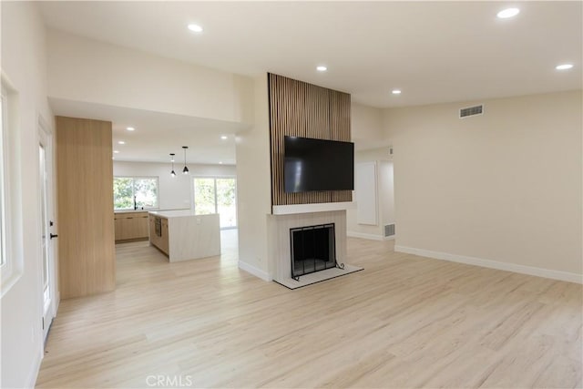 1925 Walnut Leaf Dr, Walnut, CA 91789 - unfurnished living room featuring light wood finished floors, recessed lighting, and a fireplace with raised hearth