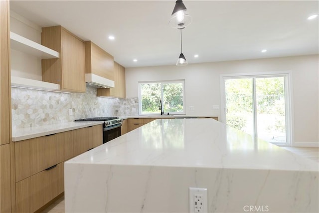 1925 Walnut Leaf Dr, Walnut, CA 91789 - kitchen with stainless steel gas stove, a kitchen island, modern cabinets, backsplash, and premium range hood