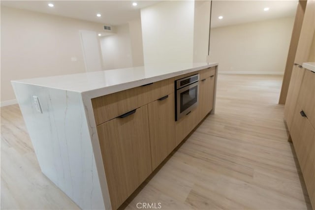 1925 Walnut Leaf Dr, Walnut, CA 91789 - kitchen featuring modern cabinets, light brown cabinetry, recessed lighting, and light wood-type flooring