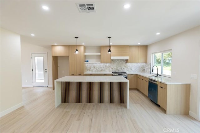 1925 Walnut Leaf Dr, Walnut, CA 91789 - kitchen with dishwashing machine, stainless steel gas range oven, light brown cabinets, light wood-type flooring, and a center island
