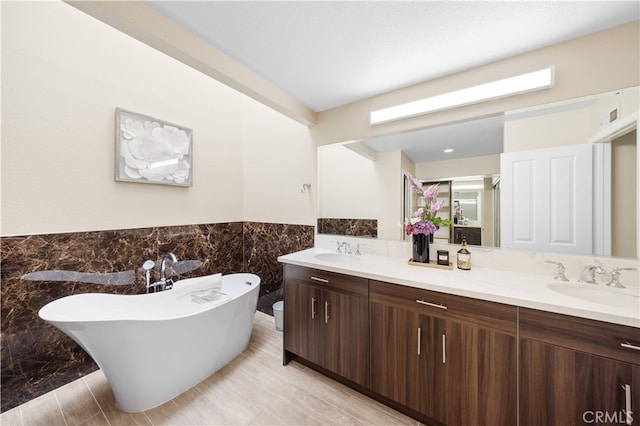 15 Valley Vw, Irvine, CA 92612 - full bath with double vanity, tile walls, a freestanding tub, and wainscoting