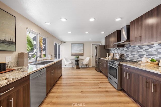 15 Valley Vw, Irvine, CA 92612 - kitchen featuring wall chimney exhaust hood, stainless steel appliances, light wood-style floors, tasteful backsplash, and recessed lighting