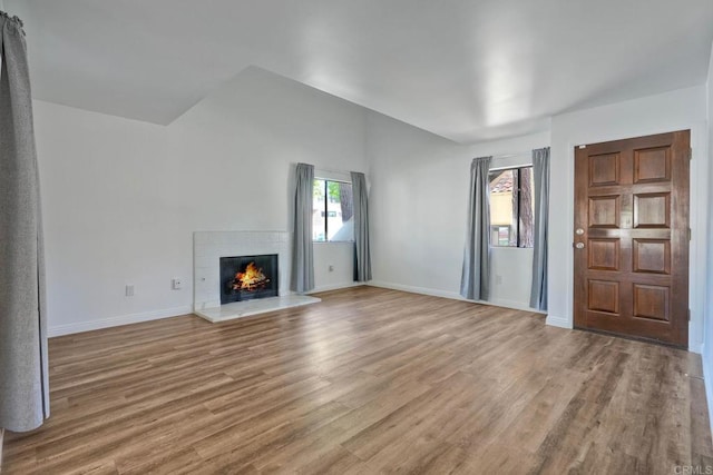 391 N Melrose Unit A, Vista, CA 92083 - unfurnished living room featuring wood finished floors and a tile fireplace