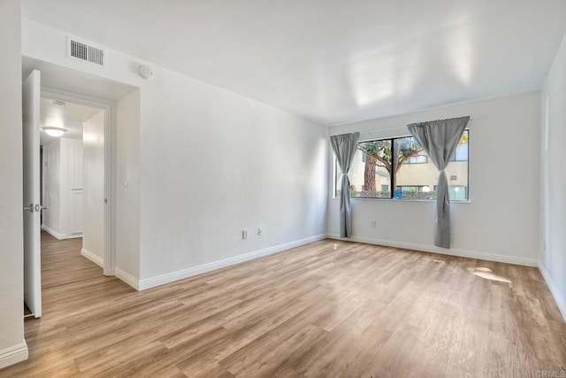391 N Melrose Unit A, Vista, CA 92083 - spare room with light wood-style floors and a smoke detector