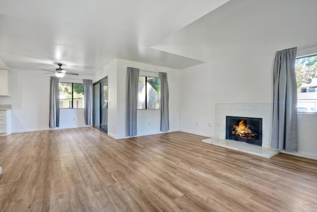 391 N Melrose Unit A, Vista, CA 92083 - unfurnished living room with a tiled fireplace, light wood-style floors, healthy amount of natural light, and a ceiling fan