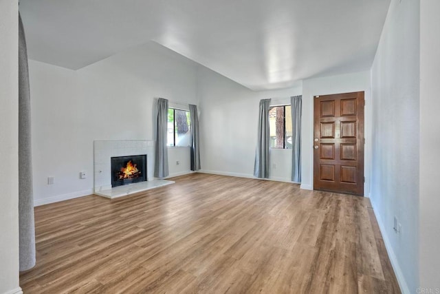 391 N Melrose Unit A, Vista, CA 92083 - unfurnished living room with light wood-type flooring and a tiled fireplace