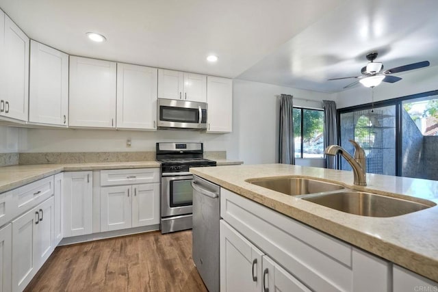 391 N Melrose Unit A, Vista, CA 92083 - kitchen with appliances with stainless steel finishes, plenty of natural light, white cabinets, and recessed lighting