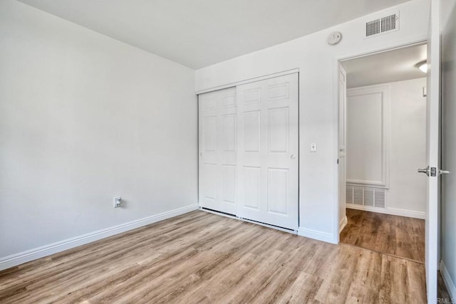 391 N Melrose Unit A, Vista, CA 92083 - unfurnished bedroom featuring wood finished floors and a closet