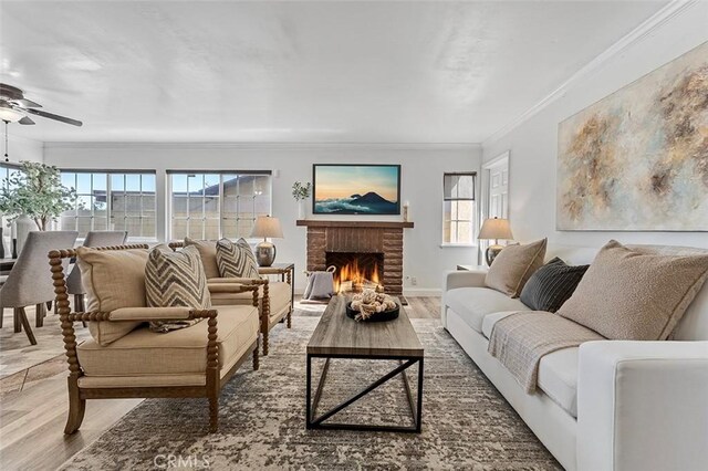 4268 Baggett Dr, Riverside, CA 92505 - living area featuring wood finished floors, a ceiling fan, plenty of natural light, a fireplace, and ornamental molding