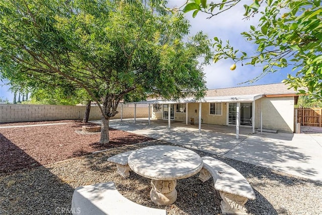 4268 Baggett Dr, Riverside, CA 92505 - rear view of house featuring a fenced backyard, stucco siding, and a patio