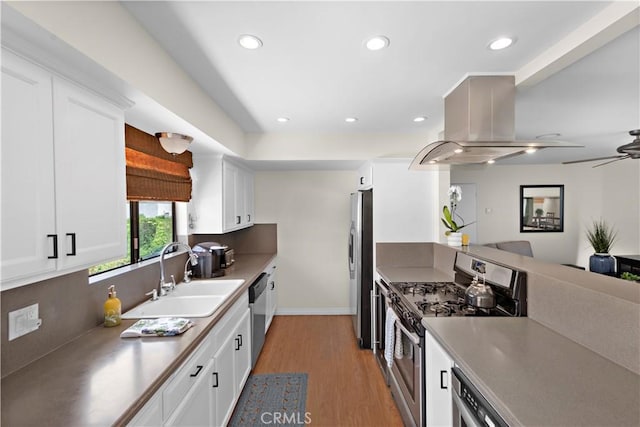 100 Calle Patricia Unit 1A, San Clemente, CA 92672 - kitchen featuring appliances with stainless steel finishes, island exhaust hood, light wood-type flooring, white cabinetry, and recessed lighting