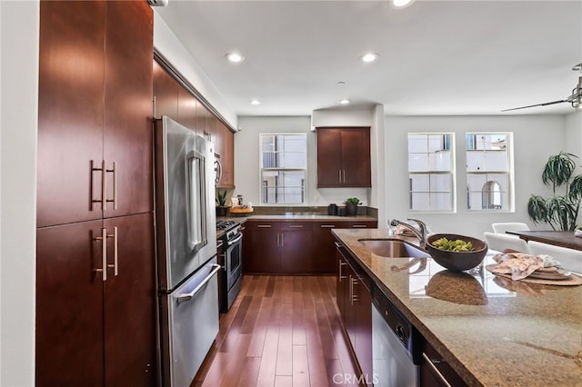 2950 19th St Unit 113, Signal Hill, CA 92707 - kitchen featuring appliances with stainless steel finishes, dark stone countertops, dark wood-type flooring, and recessed lighting