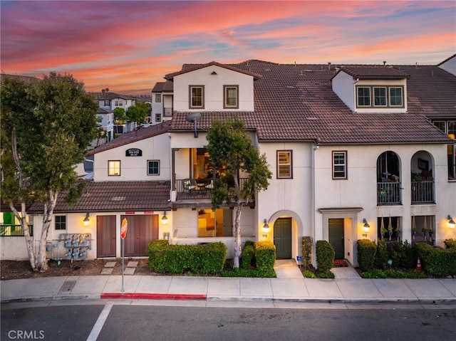 2950 19th St Unit 113, Signal Hill, CA 92707 - view of front of property with a balcony, a tile roof, and stucco siding