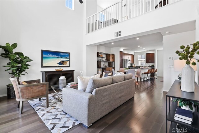 2950 19th St Unit 113, Signal Hill, CA 92707 - living area with dark wood finished floors and a towering ceiling
