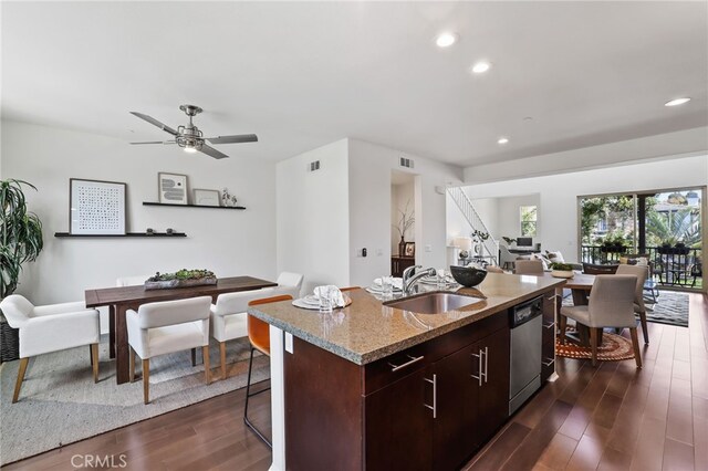 2950 19th St Unit 113, Signal Hill, CA 92707 - kitchen with dishwasher, dark wood finished floors, recessed lighting, a center island with sink, and light stone counters