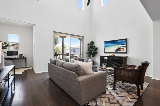 2950 19th St Unit 113, Signal Hill, CA 92707 - living room with a high ceiling, healthy amount of natural light, and dark wood-style floors