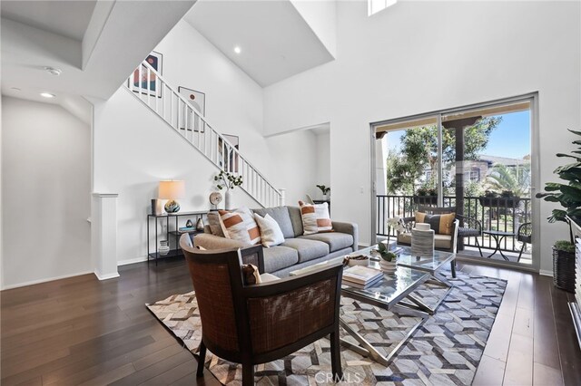 2950 19th St Unit 113, Signal Hill, CA 92707 - living room with a high ceiling, stairway, hardwood / wood-style floors, and recessed lighting